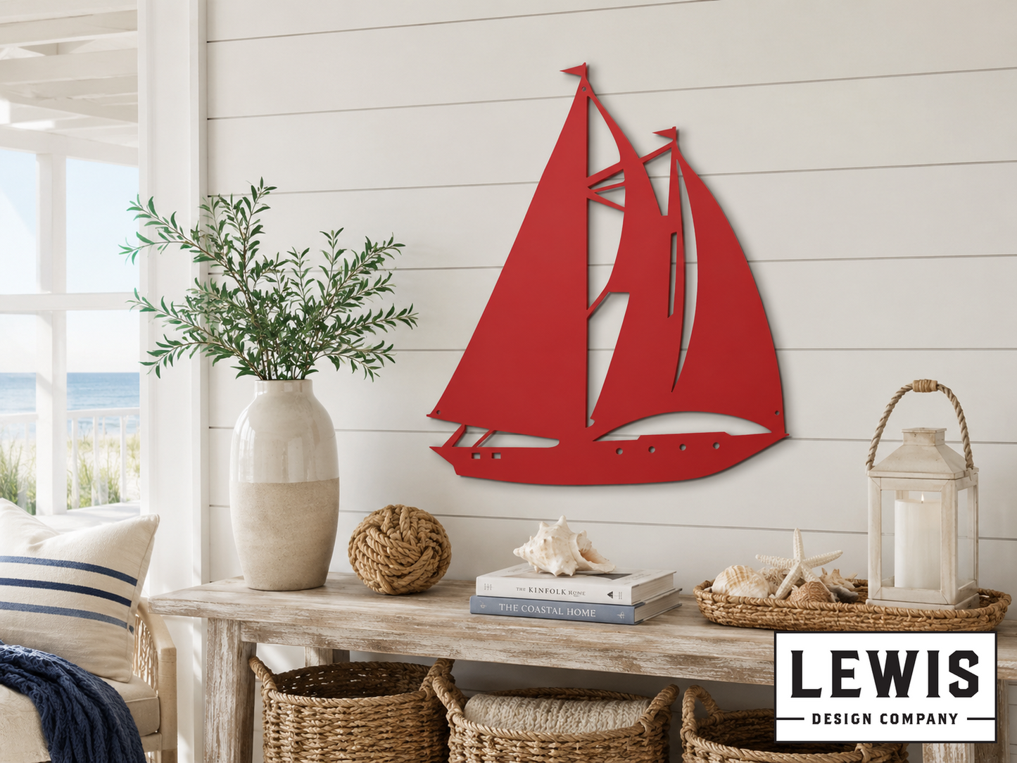 Red sailboat wall art on a white wall with a table and decor items below.