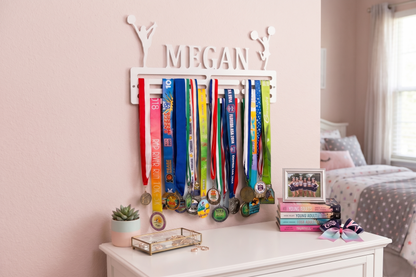 Medal holder with medals on a shelf in a bedroom. Cheerleader Medal and Award Hanger.  Cheer Award Display