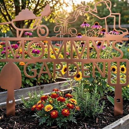 Decorative metal sign with 'Mommy's Garden' in a garden setting with flowers and plants.