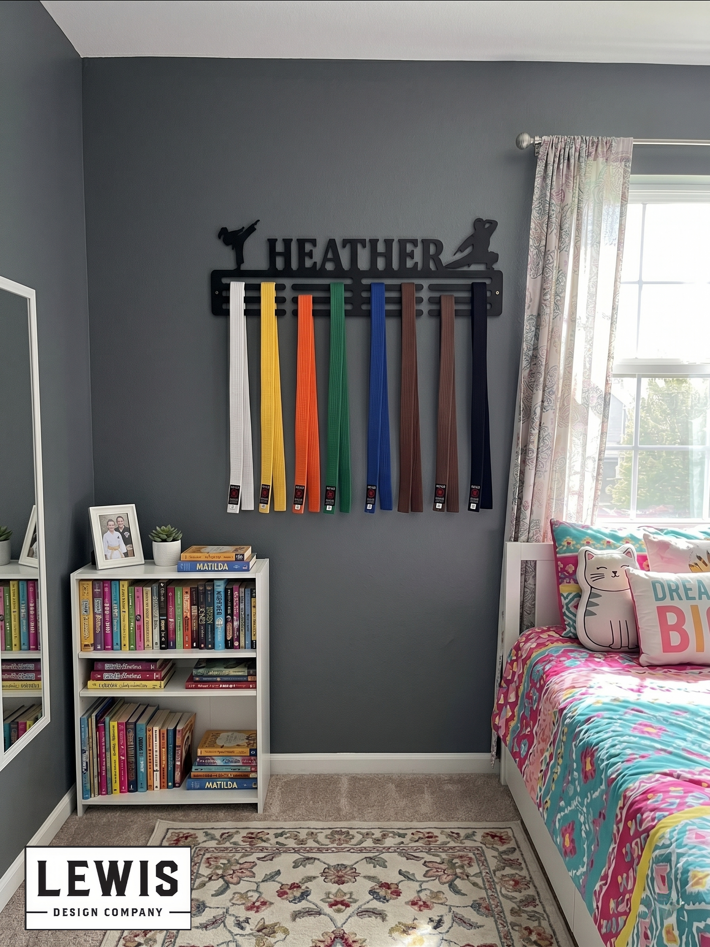 Medal holder with medals and ribbons on a wall, branded 'LEWIS Design Company'. Female Karate Medal and Award Display