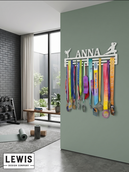 Medal holder with medals and ribbons on a wall, branded 'LEWIS Design Company'. Female Karate Medal and Award Display