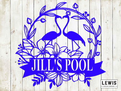 Decorative design with flamingos and floral elements on a wooden background, featuring the text 'JILL'S POOL' and 'LEWIS Design Company'.