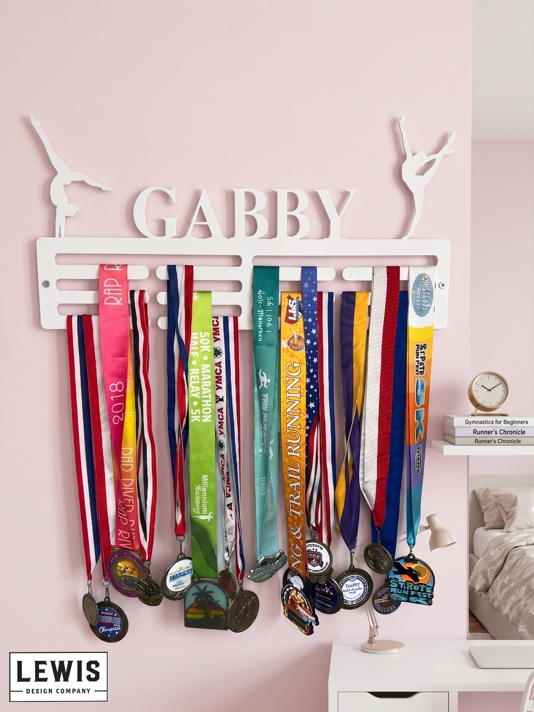 Medal holder with medals hanging on a pink wall, featuring the name 'Gabby' above. Gymnastics Medal Hanger