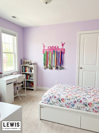Children's bedroom with a desk, bookshelf, and bed with a floral comforter. Medal display on the wall. Gymnastics Medal Hanger