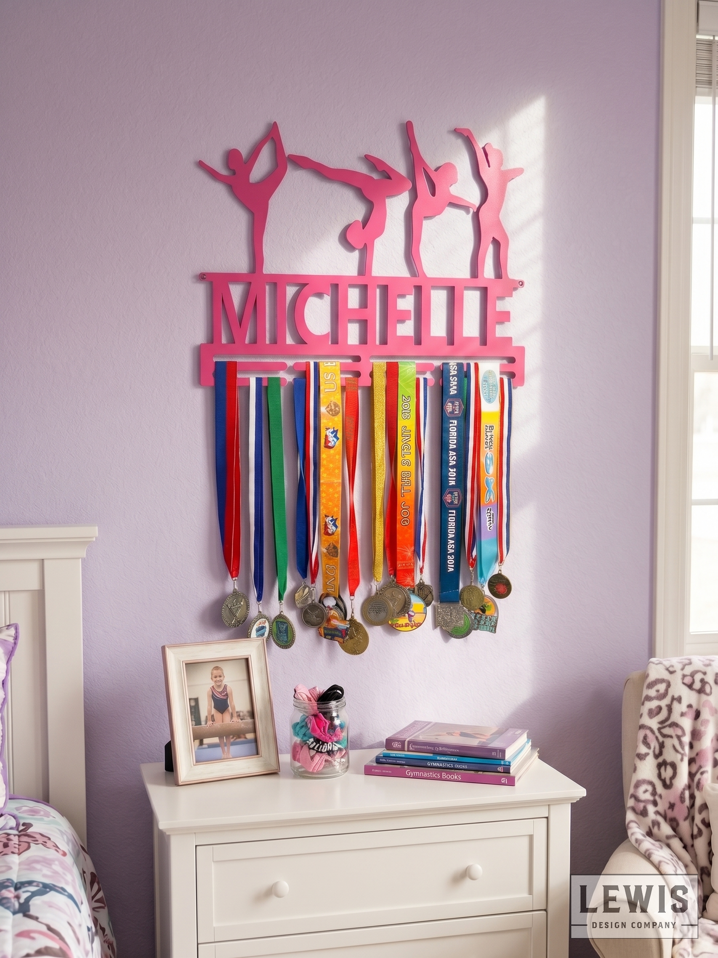 Pink medal holder with medals hanging on a wall in a bedroom.