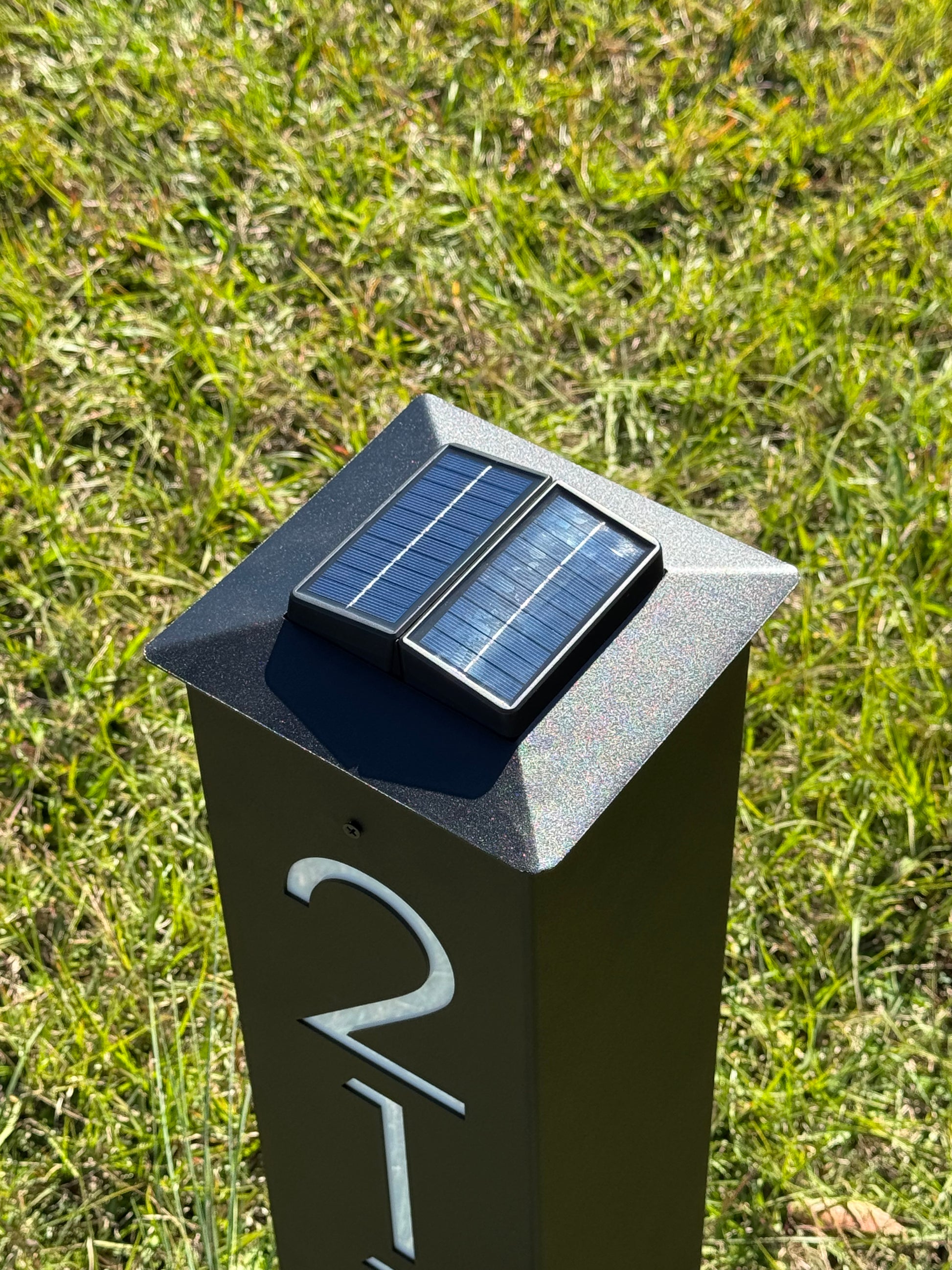 Replacement solar light cap installed on a Lewis Design Company metal address post in black finish