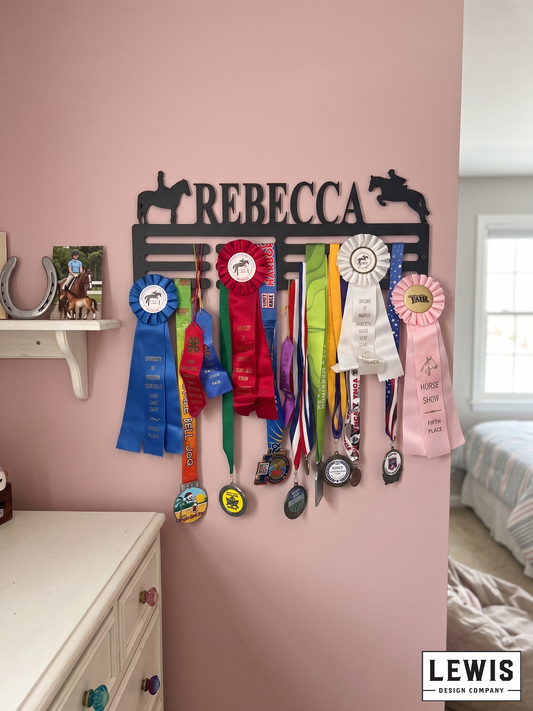 Horse-themed ribbon holder with colorful ribbons on a pink wall, featuring the name 'Rebecca'.