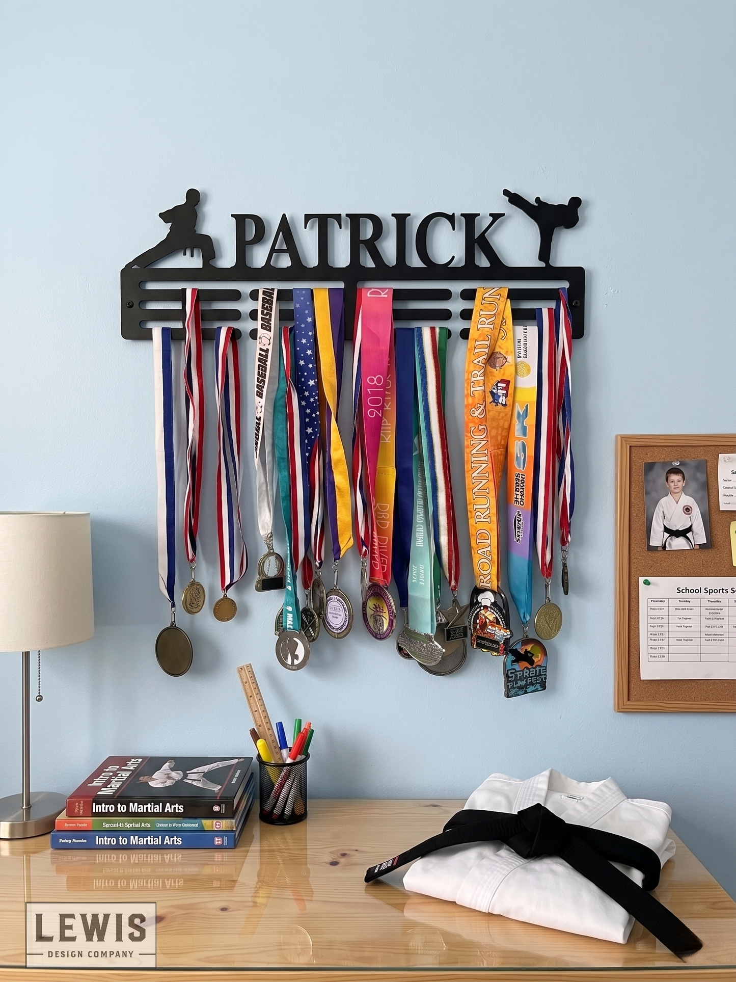 Karate Medal holder with medals on a wall above a desk with books and a lamp.