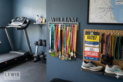 Gym interior with a treadmill, weights, and medal display on a blue wall.