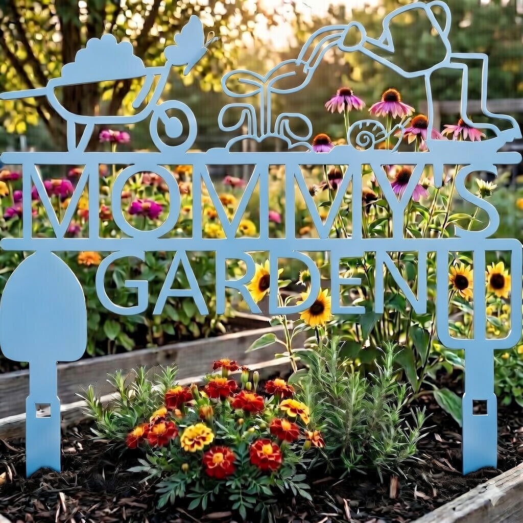 Decorative metal sign with 'Mommy Garden' in a garden setting with flowers.