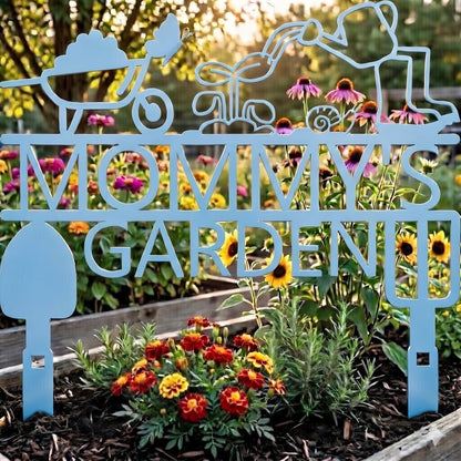 Decorative metal sign with 'Mommy Garden' in a garden setting with flowers.