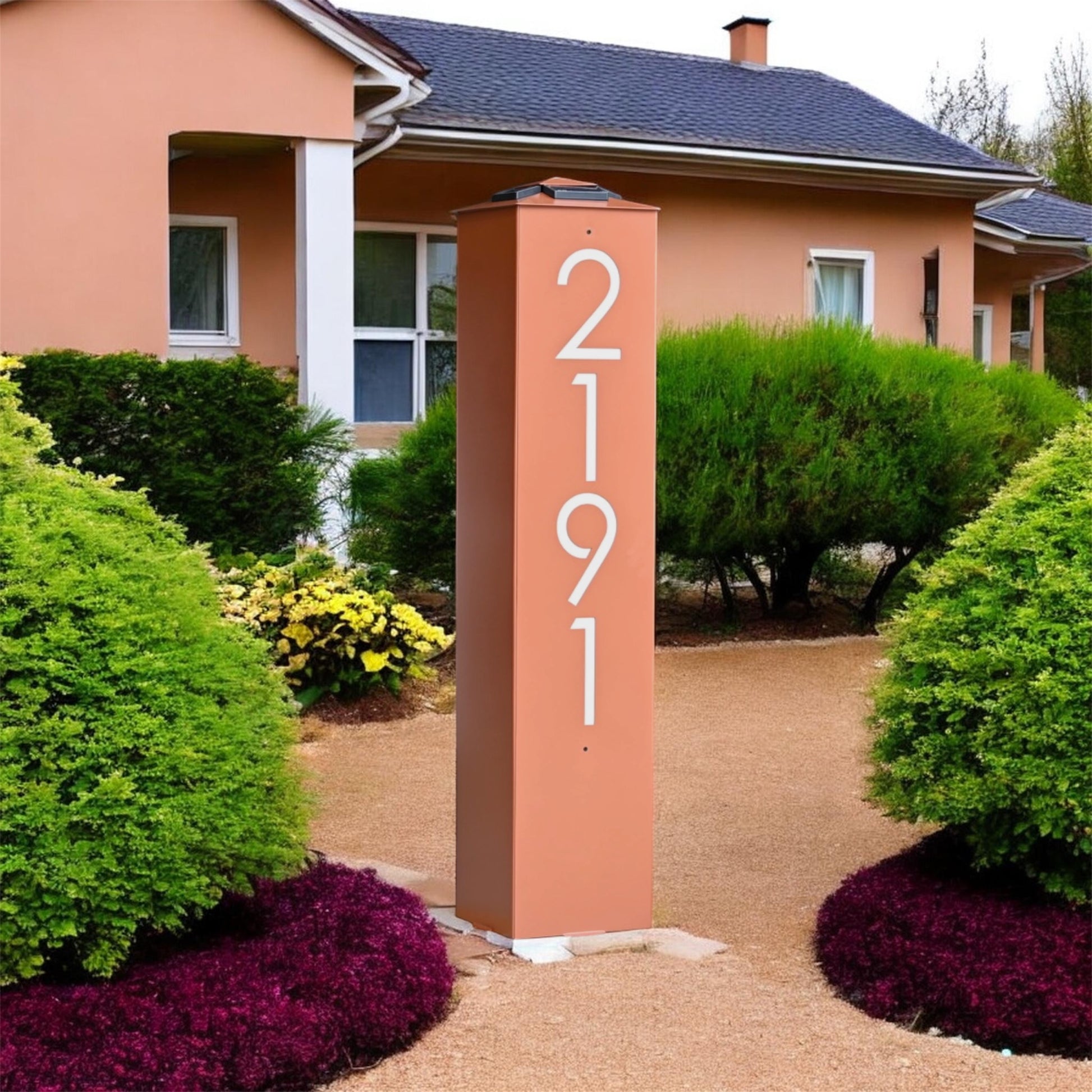 House with a decorative address column featuring the number '2191' in a garden setting.