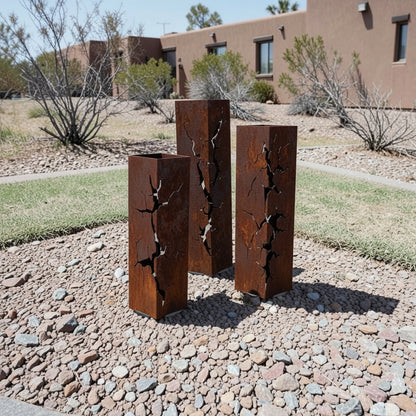 Rusted decorative posts in a rocky flower bed