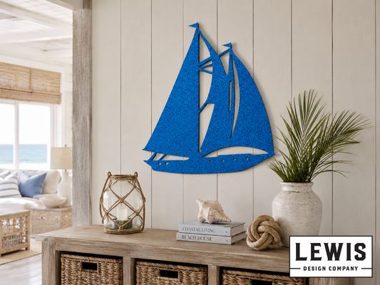 Blue sailboat wall art in a living room with a coastal theme.