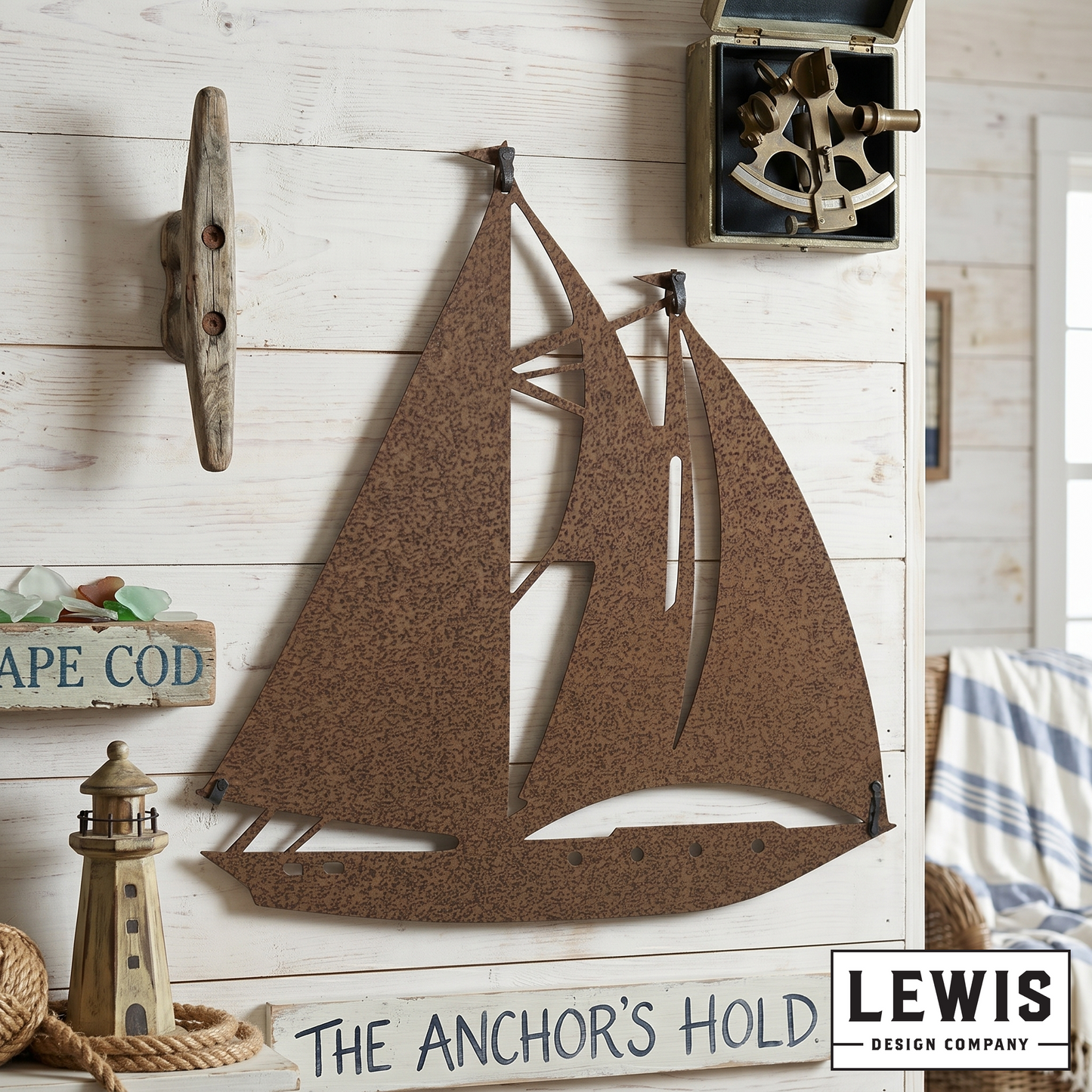 Decorative sailboat wall art with 'The Anchor's Hold' sign and Lewis Design Company logo.