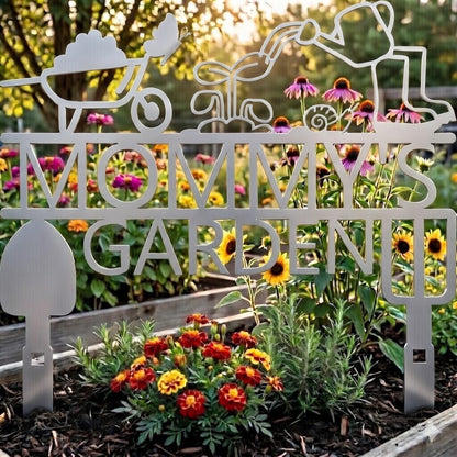 Decorative metal sign with 'Mommy's Garden' in a garden setting with flowers.