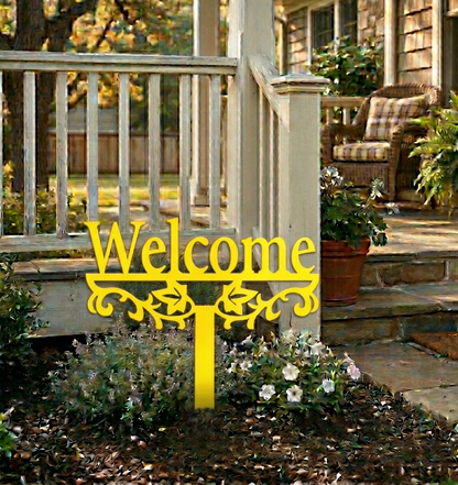 Yellow 'Welcome' sign on a garden with a house in the background