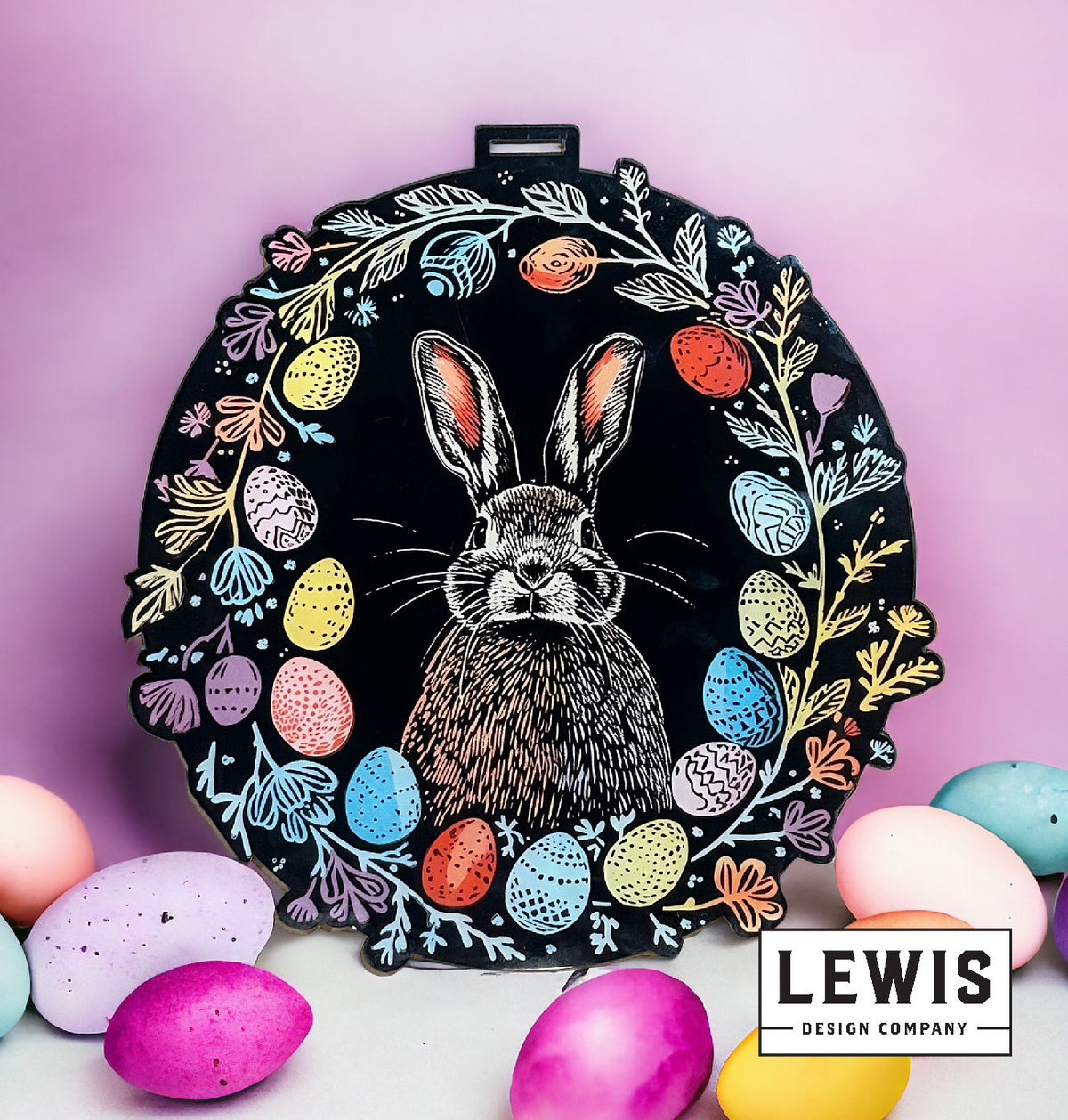 Decorative plate with a rabbit illustration surrounded by colorful eggs on a pink background, featuring the Lewis Design Company logo.