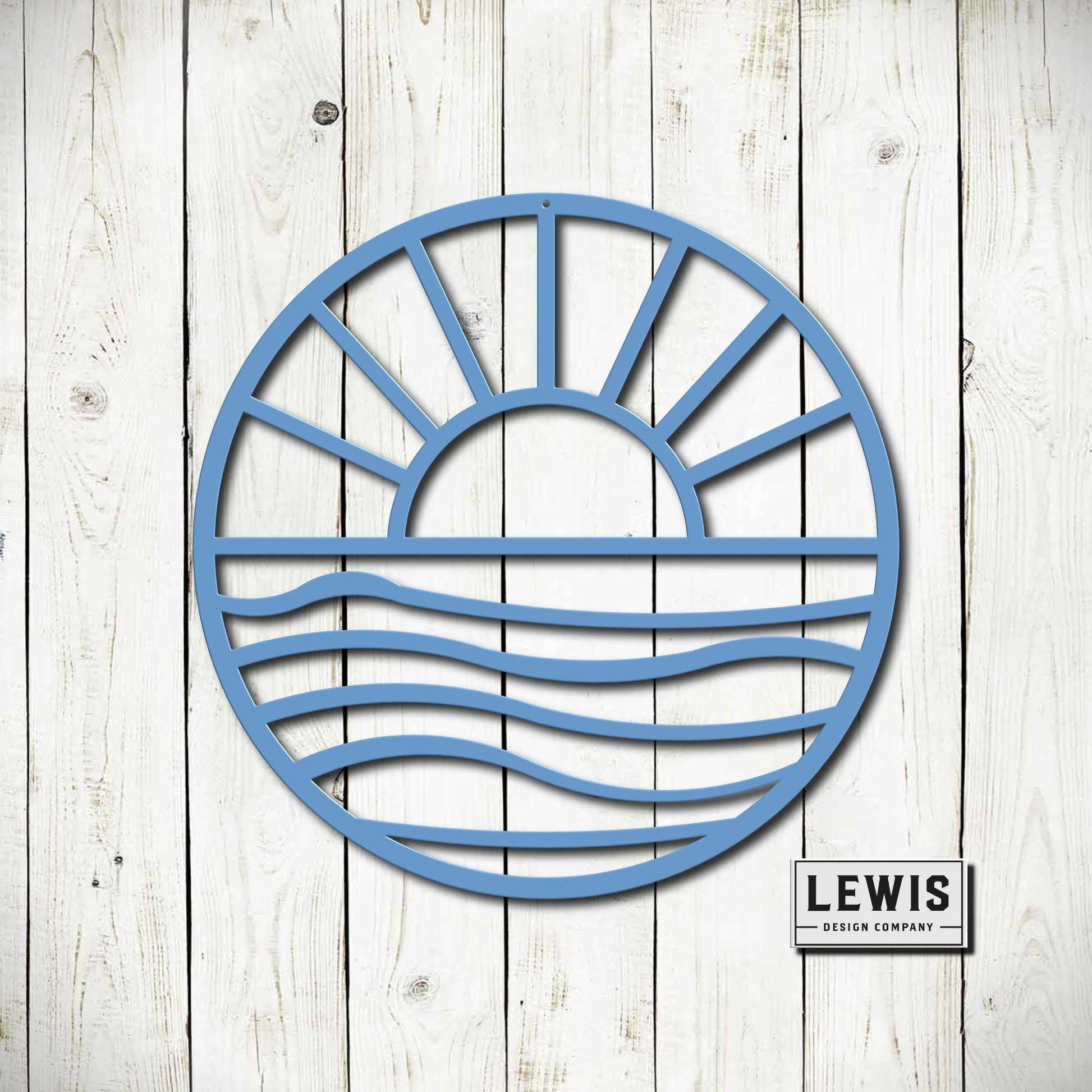 Handmade Sun and Waves metal wall art in light blue displayed on white wood planks by Lewis Design Company